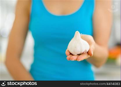 Closeup on garlic in hand of woman