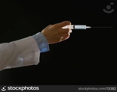 Closeup on hand of medical doctor with syringe isolated on black