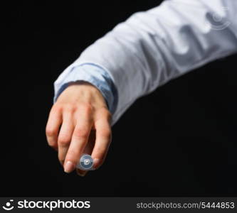 Closeup on hand with syringe isolated on black