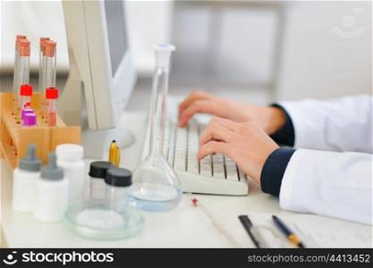 Closeup on hands of medical doctor working on computer