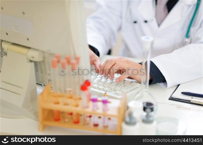 Closeup on hands of medical doctor working on pc