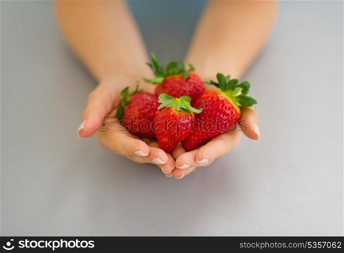 Closeup on hands with strawberries