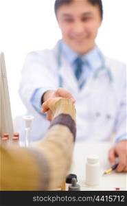 Closeup on handshake of medical doctor and patient