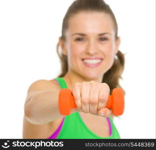 Closeup on happy fitness young woman making exercise with dumbbells