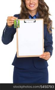 Closeup on happy realtor woman with keys showing blank clipboard