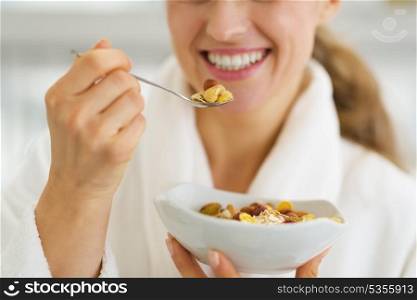 Closeup on happy woman in bathrobe having healthy breakfast
