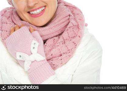 Closeup on happy woman in knit scarf and mittens