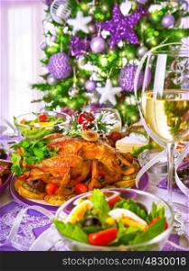 Closeup on homemade Christmastime dinner on beautiful decorated Christmas tree background, delicious grill chicken in centerpiece of festive table&#xA;