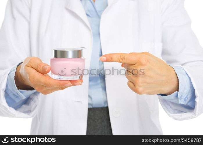 Closeup on kosmetist woman pointing on creme