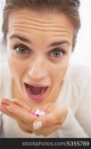 Closeup on mad woman eating handful of pills