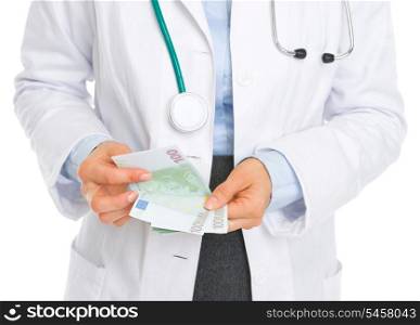 Closeup on medical doctor counting euros
