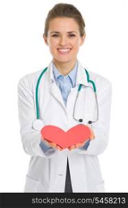 Closeup on medical doctor woman giving paper heart
