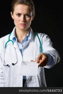 Closeup on medical doctor woman giving prescription isolated on black