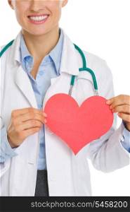 Closeup on medical doctor woman holding paper heart