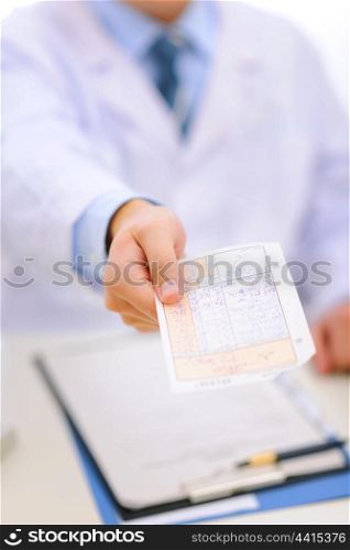 Closeup on medical prescription in hand of doctor