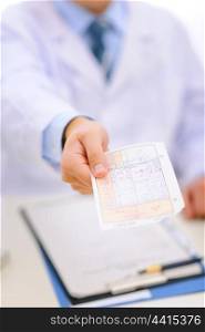 Closeup on medical prescription in hand of doctor