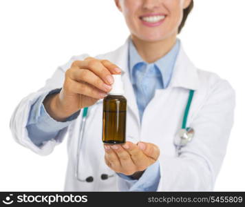 Closeup on medicine bottle in hand of doctor woman