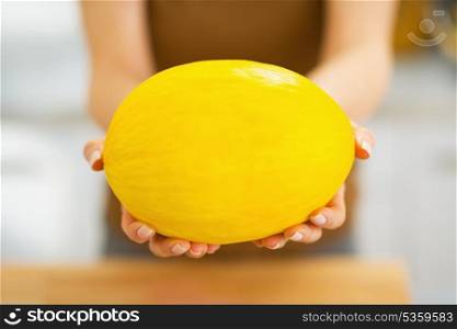Closeup on melon in hand of woman
