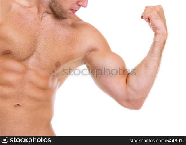 Closeup on muscular man showing abdominal muscles and biceps
