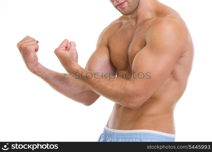 Closeup on muscular man showing biceps