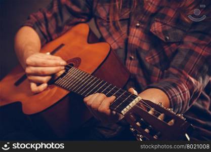 Closeup on musical instrument.. Closeup on musical instrument. Young person holding guitar. Music sound hobby passion concept.