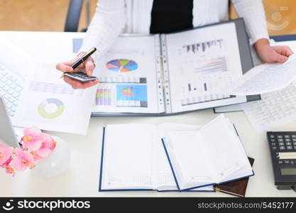 Closeup on office table and working business woman