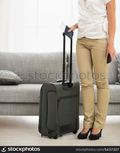 Closeup on passport, air ticket and bag in female hands