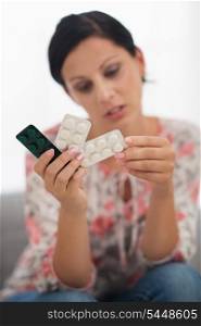 Closeup on pills in hand of concerned young woman