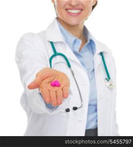 Closeup on pills in hand of doctor woman