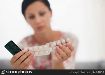 Closeup on pills in hand of woman