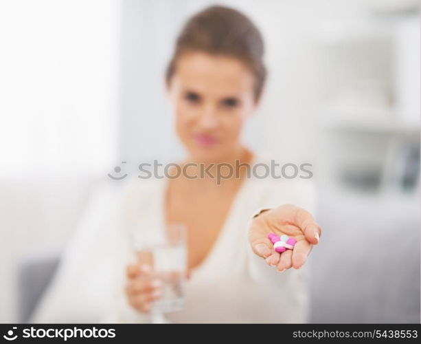 Closeup on pills in hand of young woman