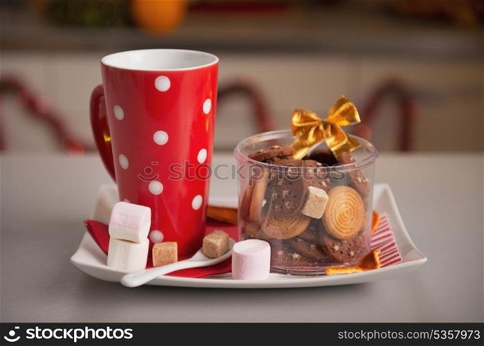 Closeup on plate with christmas cookies and cup of hot chocolate with marshmallow