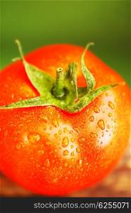 Closeup on red tomato with water drops shallow DOF