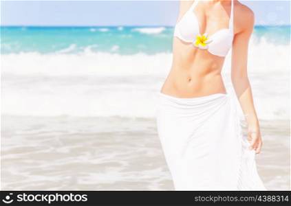 Closeup on sexy woman on the beach, body part, stylish white swimwear, beautiful blue sea, summer holiday, day spa, slim female body, healthy lifestyle