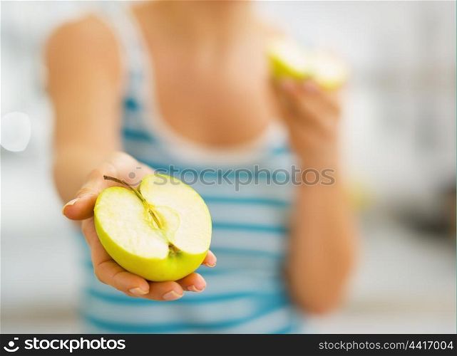 Closeup on slices of apple in hand of young woman
