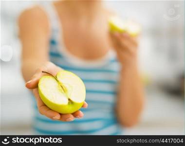 Closeup on slices of apple in hand of young woman