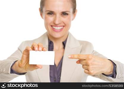 Closeup on smiling business woman pointing on business card