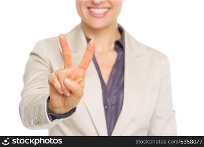 Closeup on smiling business woman showing victory gesture