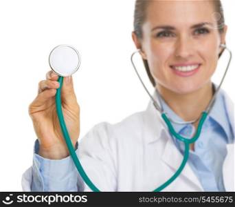 Closeup on smiling doctor woman using stethoscope