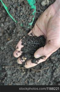 closeup on soil in gardener hand