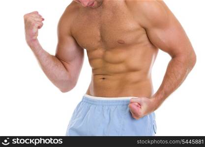 Closeup on sports man showing muscles of torso and biceps
