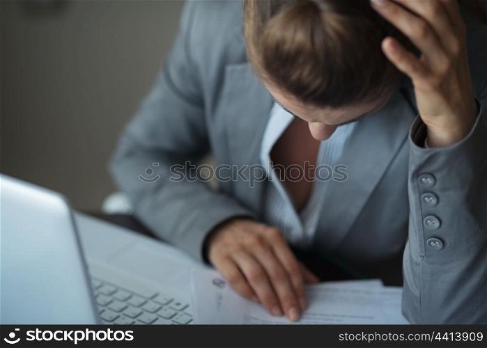 Closeup on stressed business woman working with documents
