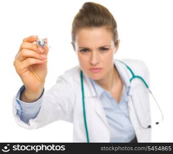 Closeup on syringe in hand of doctor woman