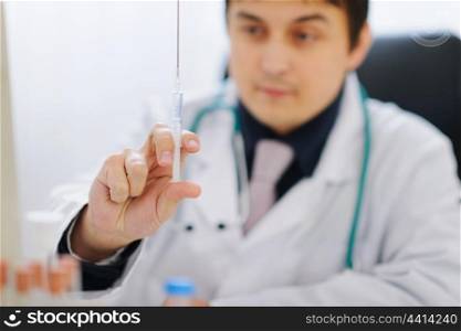Closeup on syringe in hand of medical doctor