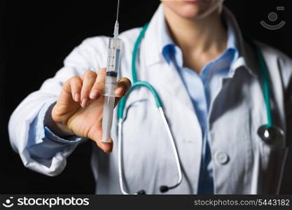 Closeup on syringe in hand of medical doctor woman