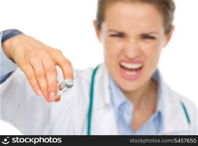 Closeup on syringe in hands of frightening medical doctor