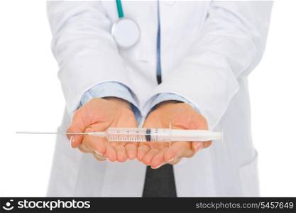 Closeup on syringe in hands of medical doctor