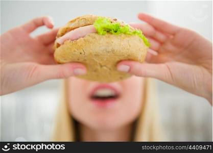 Closeup on teenager girl eating burger