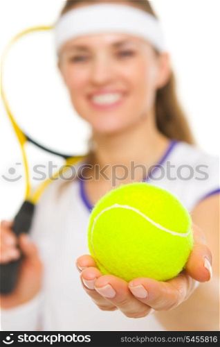 Closeup on tennis ball in hand of female tennis player