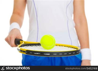 Closeup on tennis ball on racket in hand of tennis player